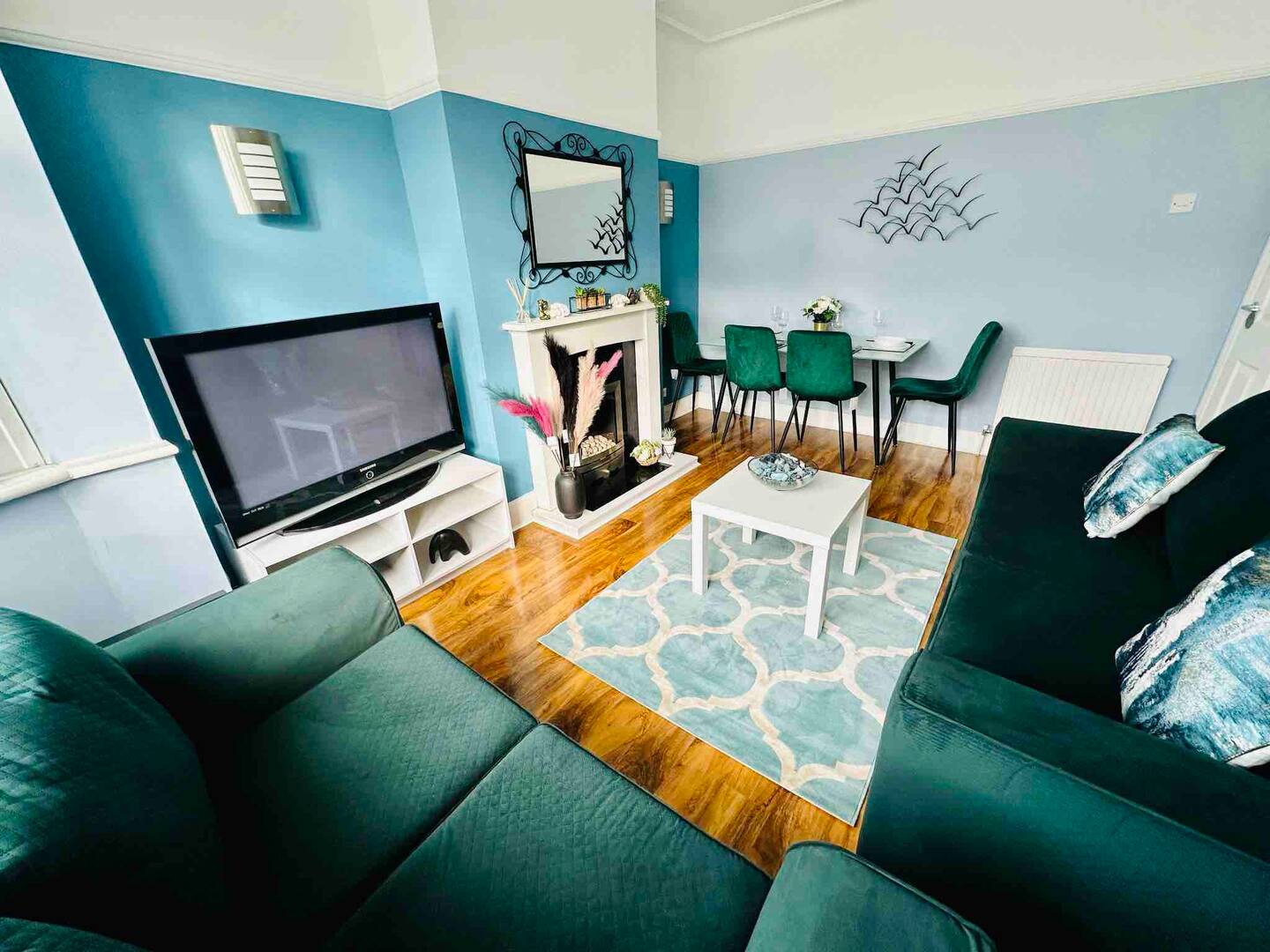 The Esplanade Interiors logo features a clean and inviting design, perfectly reflecting the brand's focus on custom interior design and builds in Southend-on-Sea. The logo showcases a charming outline of a coastal-style house with large windows, a pointed roof, and symmetrical palm trees on either side, evoking a sense of coastal elegance and relaxation. Beneath the house illustration, the brand name "Esplanade Interiors" is written in a modern, stylish font. "Esplanade" is in a soft gradient of blue shades, symbolising calmness and creativity, while "Interiors" is in a bold, deep navy blue, emphasising sophistication and professionalism. The overall design conveys a harmonious blend of coastal charm and high-quality craftsmanship, reflecting their bespoke interior design expertise tailored to the vibrant seaside lifestyle of Southend-on-Sea.